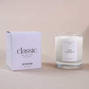 Classic Amaraa soy wax candle with box, hand poured, labeled Stay Confident, on beige background.